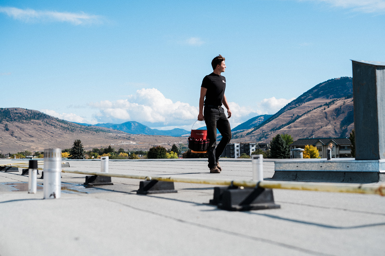 Maxwell Mechanical team member works on a roof in Kamloops after outsourcing their marketing to a creative agency