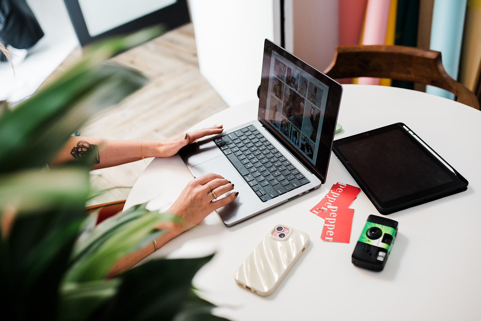 Workspace setup with laptop, tablet, and camera gear used for content planning, showcasing digital marketing and branding work by Kamloops marketing agency