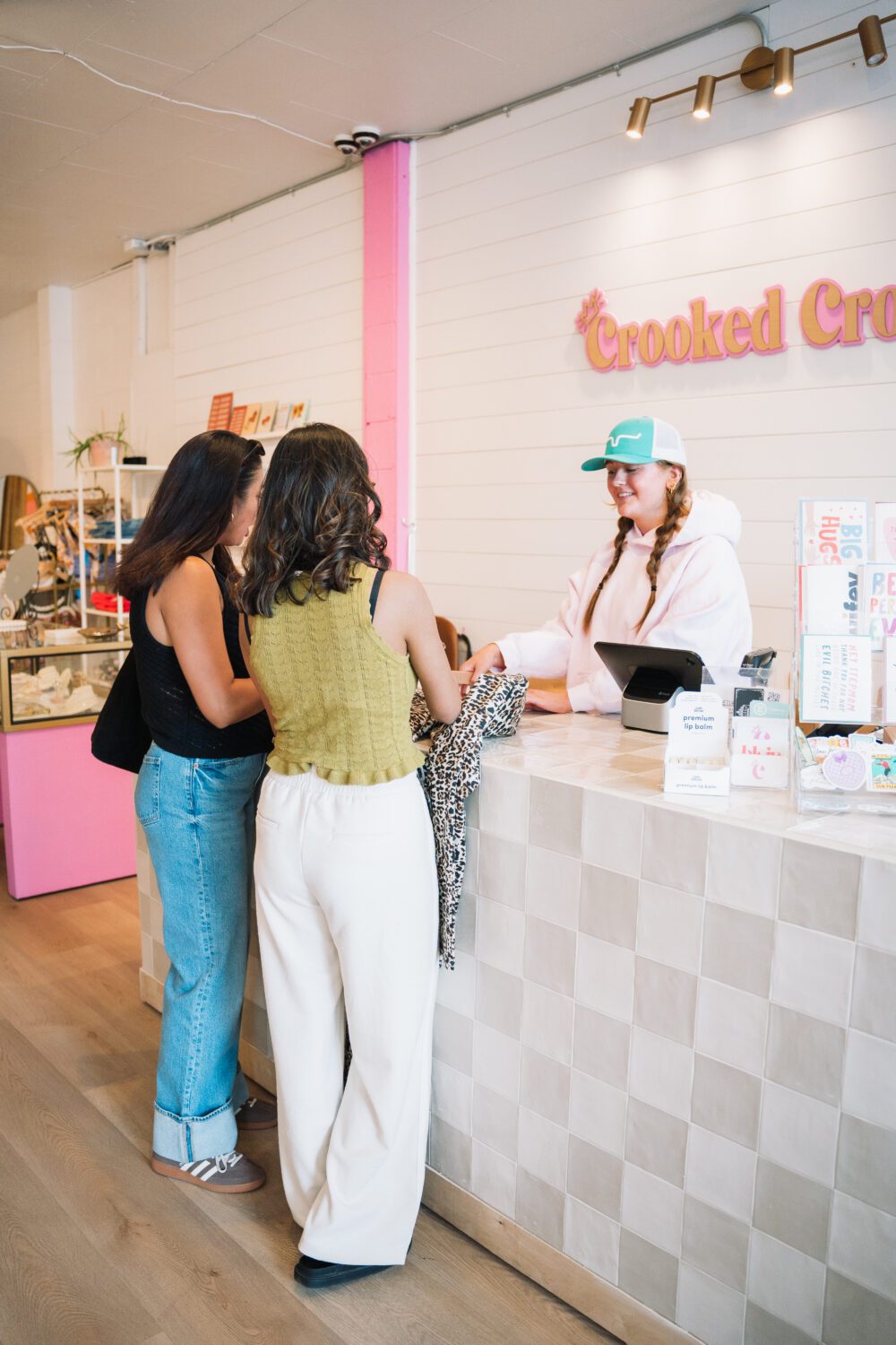 Two shoppers chat with a team member at the counter inside Crooked Crown in downtown Kamloops.
