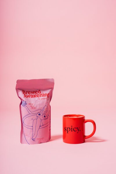 Pink coffee bag and red mug displayed on a pink background in a clean product photography setup designed for branding, packaging design, and marketing materials.