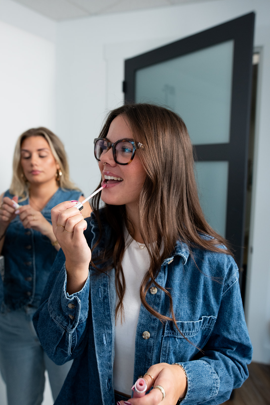 Pepper team member applying lip gloss during behind-the-scenes content shoot, representing lifestyle branding and marketing content creation