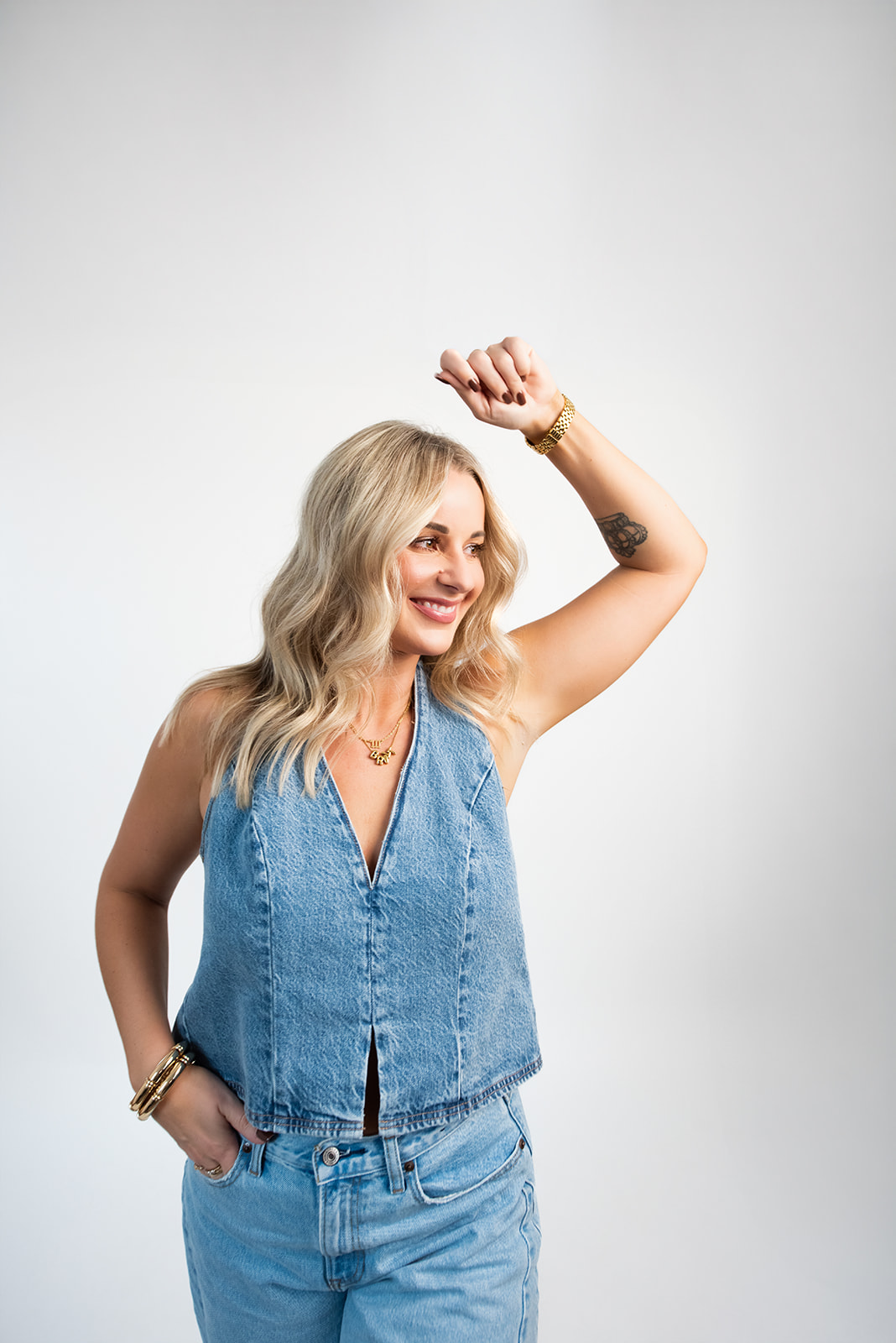 Pepper team member posing in denim outfit against studio background during branding and content creation photoshoot