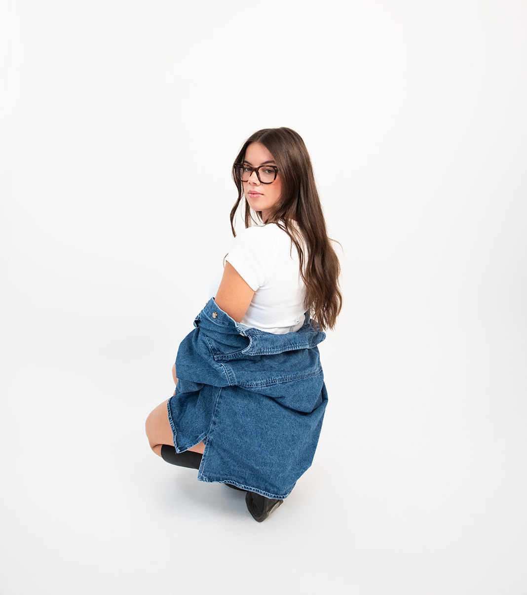 Pepper marketing team member posing in studio with casual denim outfit during brand photoshoot for content creation and social media
