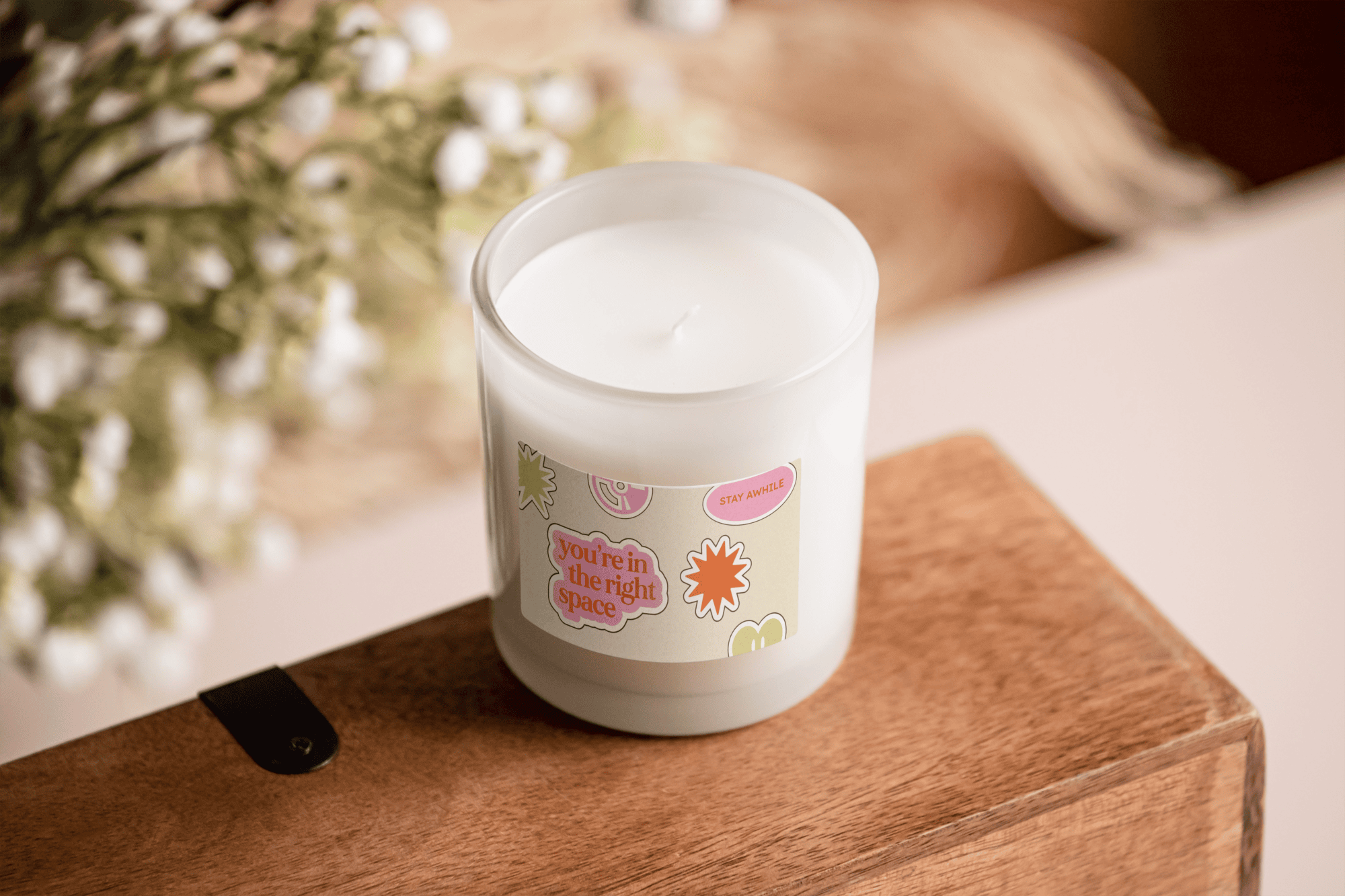 White candle featuring The Therapy Room’s playful brand graphics and “You’re in the right space” messaging created by Pepper as part of the Visual Identity.
