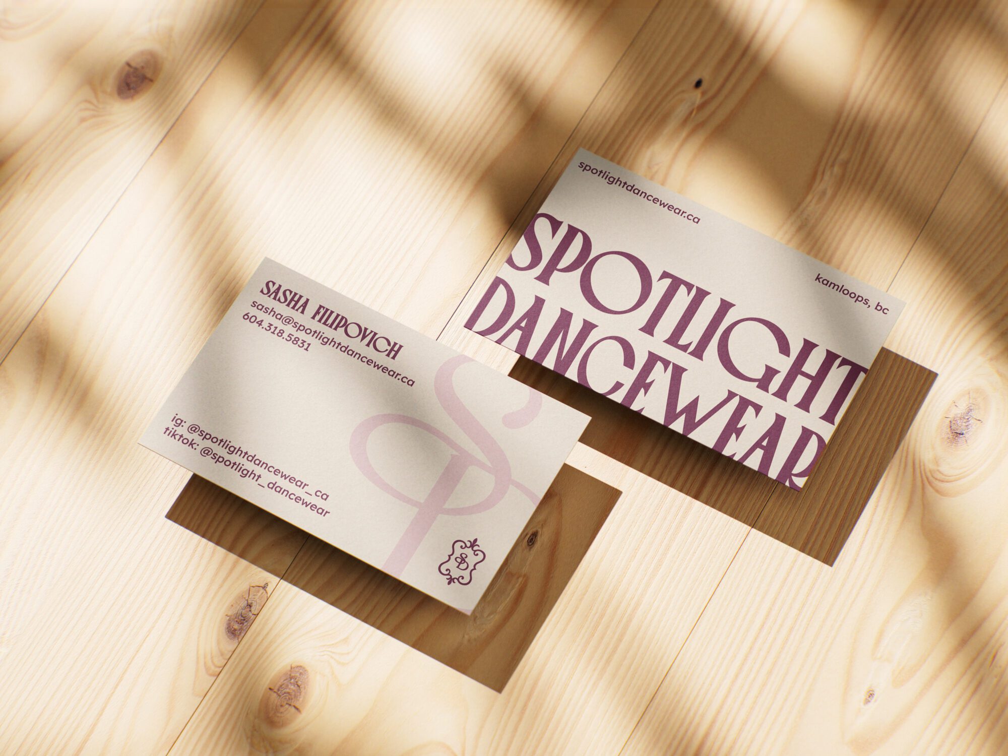 Spotlight Dancewear brand identity featuring custom business card design with elegant typography and monogram created by Pepper Marketing.