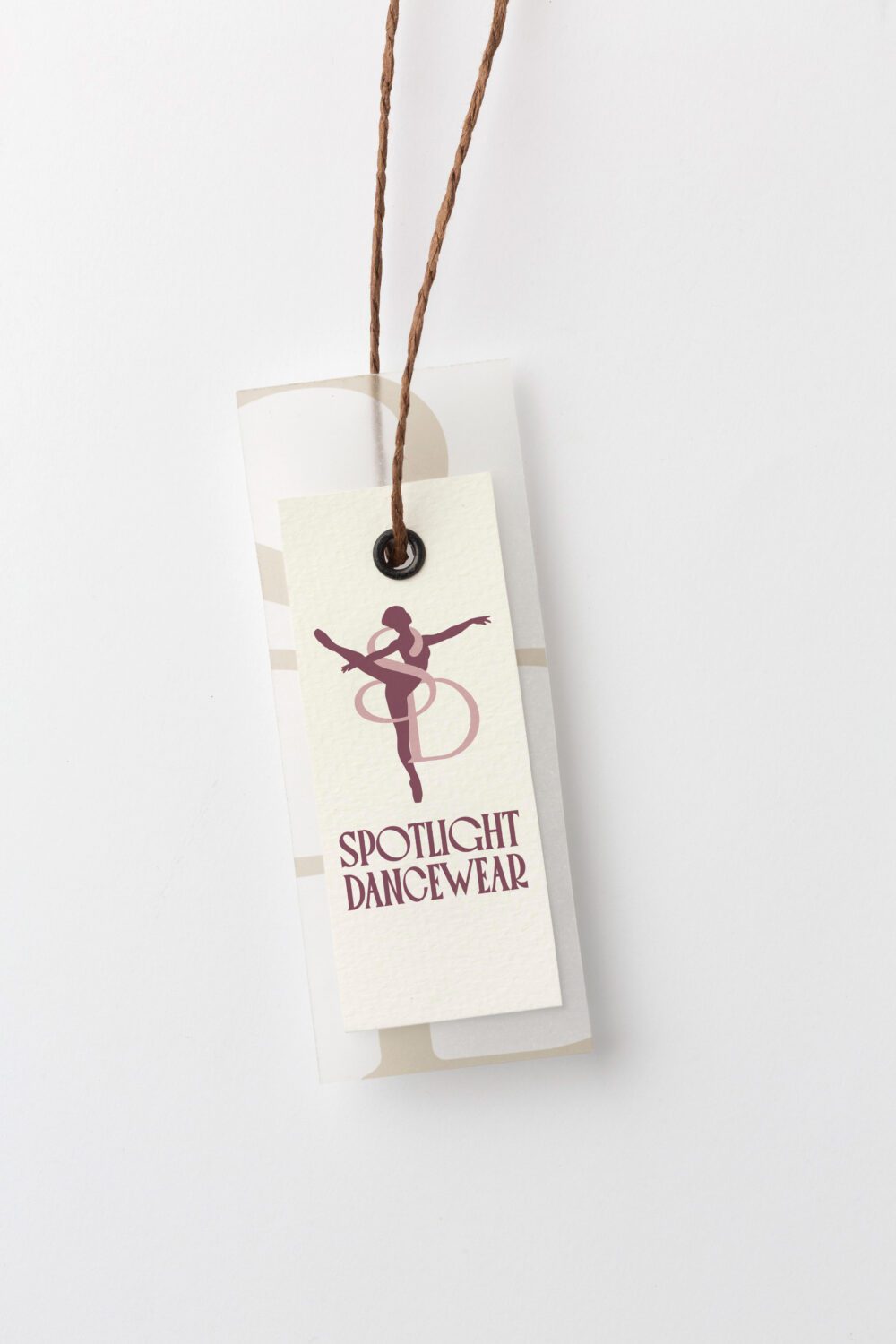 Spotlight Dancewear clothing hang tag featuring custom dancer logo, premium packaging design, and brand identity by Pepper Marketing.