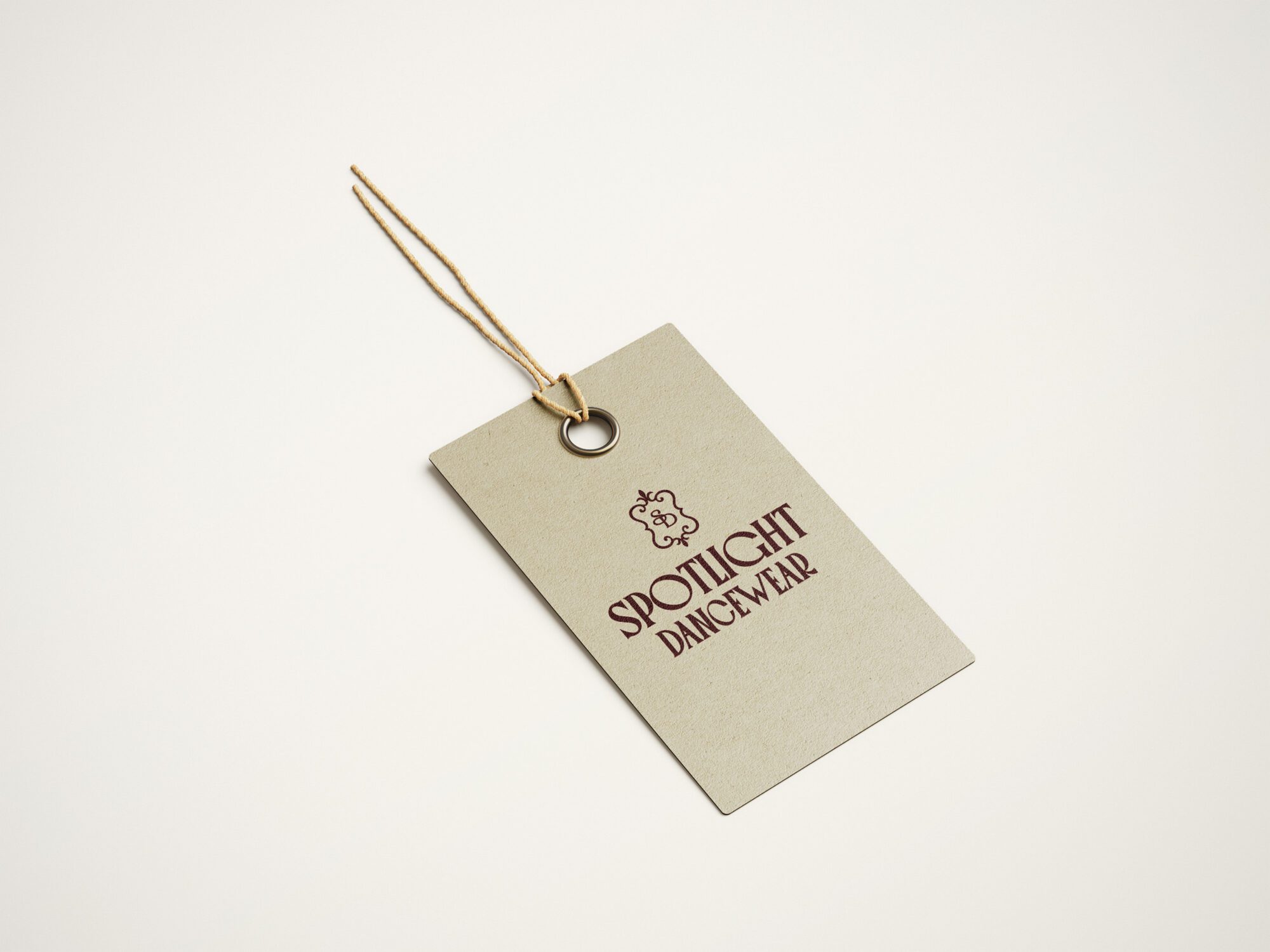 Spotlight Dancewear branded clothing tag with custom logo and premium retail packaging designed by Pepper Marketing.